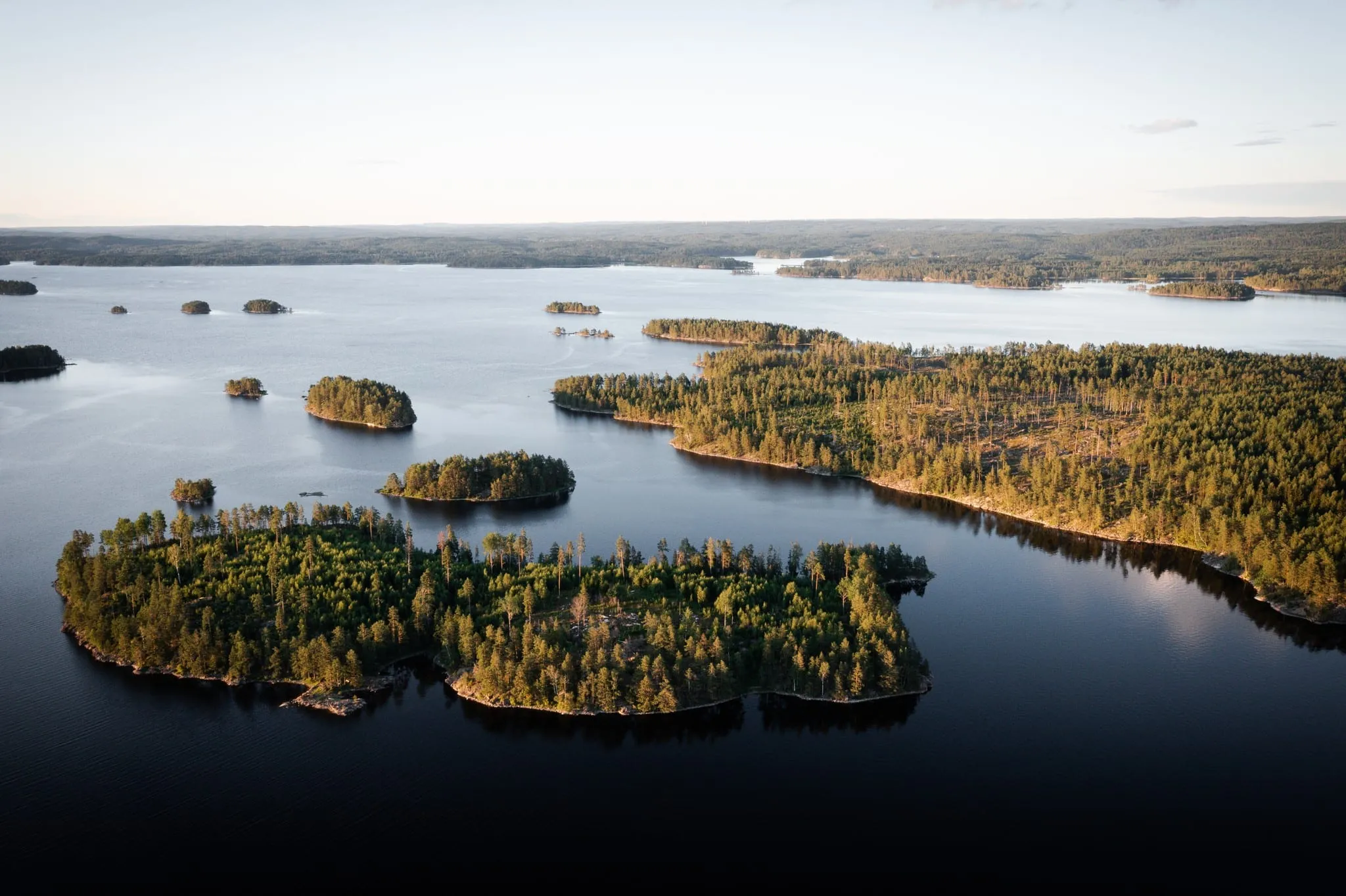 A calm forest lake in western Värmland at sunset